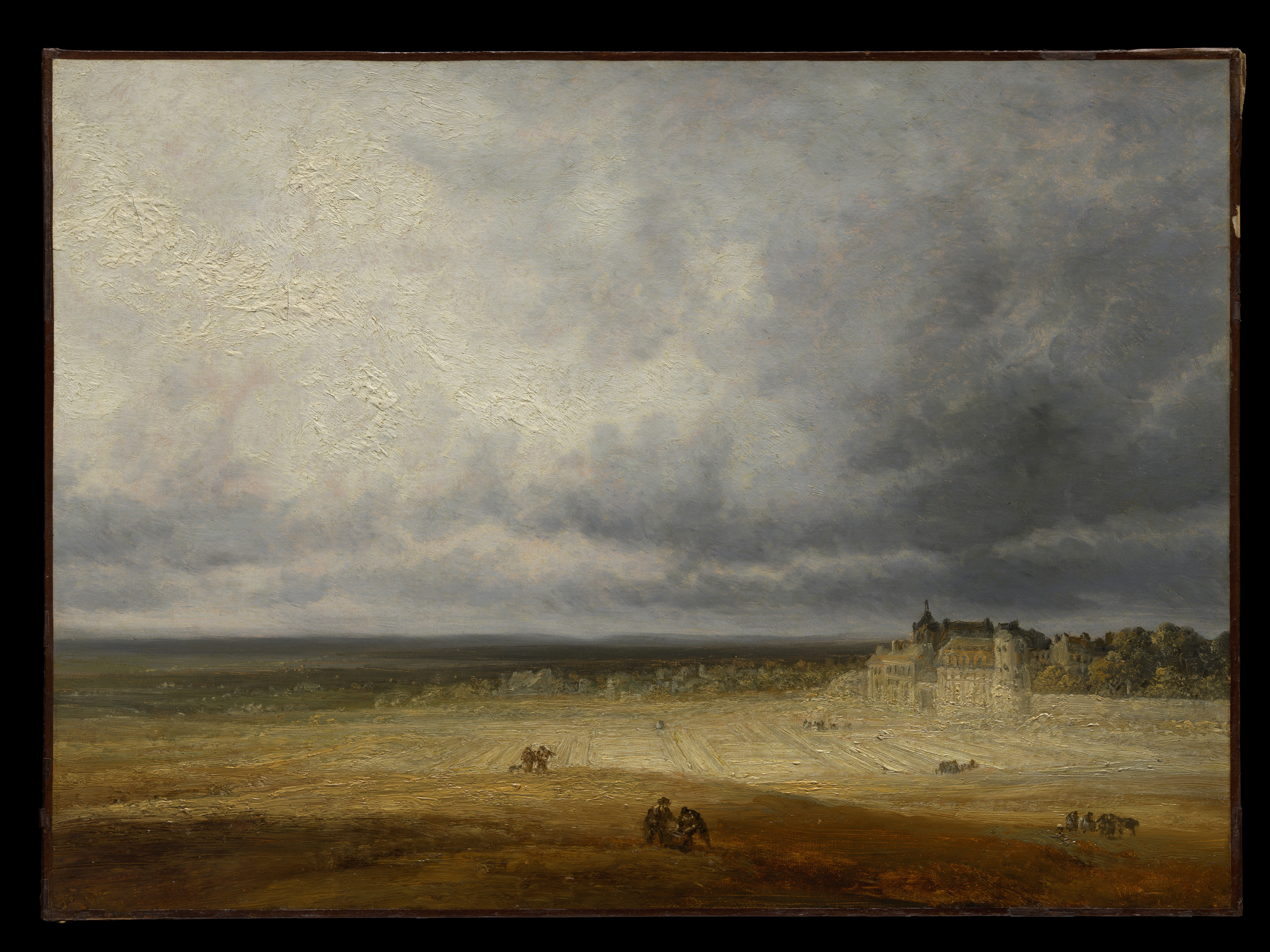 A wide French countryside under heavy clouds, with a freshly plowed field in the foreground and a small village in the middle distance.